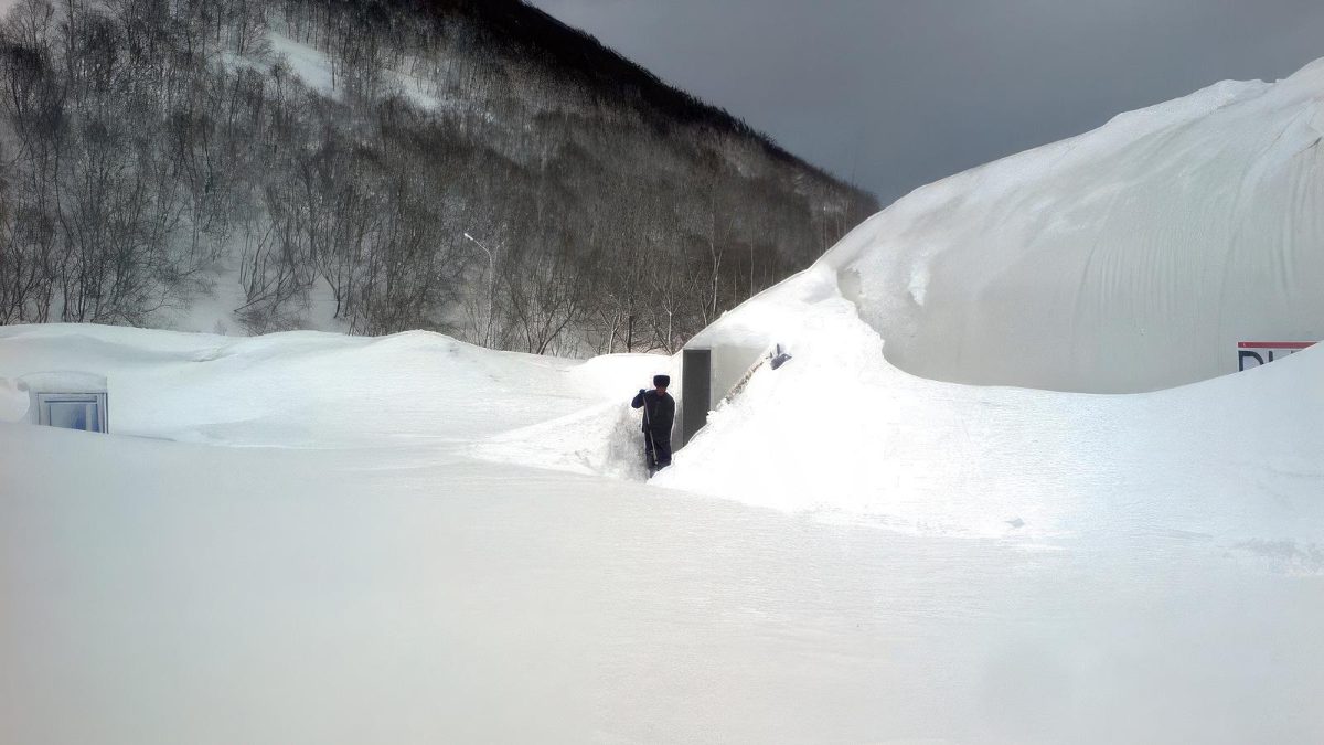 DUOL Traglufthalle unter meterhohem Schnee, Person zum Grössenvergleich